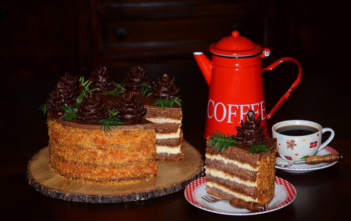 Chocolate cake with pine cone decorations and coffee