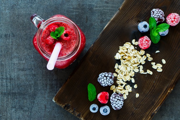Berry Smoothie with Oats and Mint on Cutting Board
