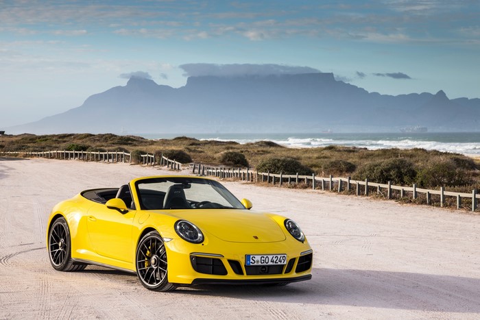 Yellow Porsche 911 Carrera 4 GTS Cabriolet on Beach
