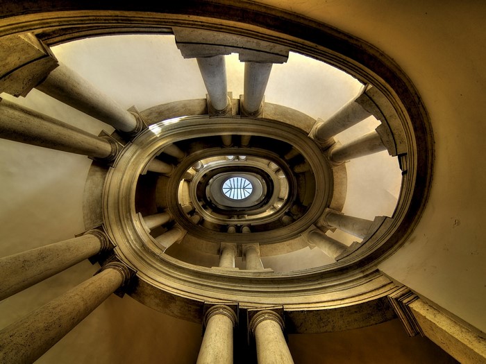 Spiral staircase with columns and skylight