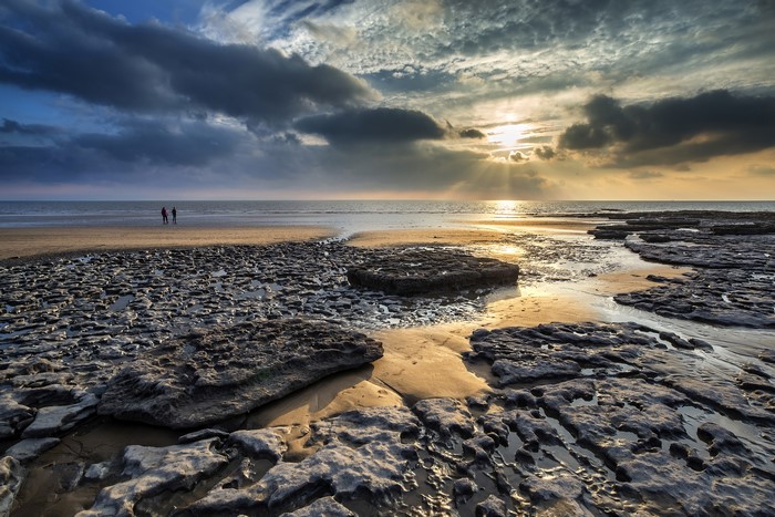Dunraven Bay, Wales: Sunset over rocky beach with two people