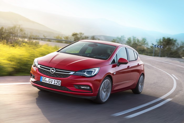 Red Opel Astra 2015 Driving on a Winding Road
