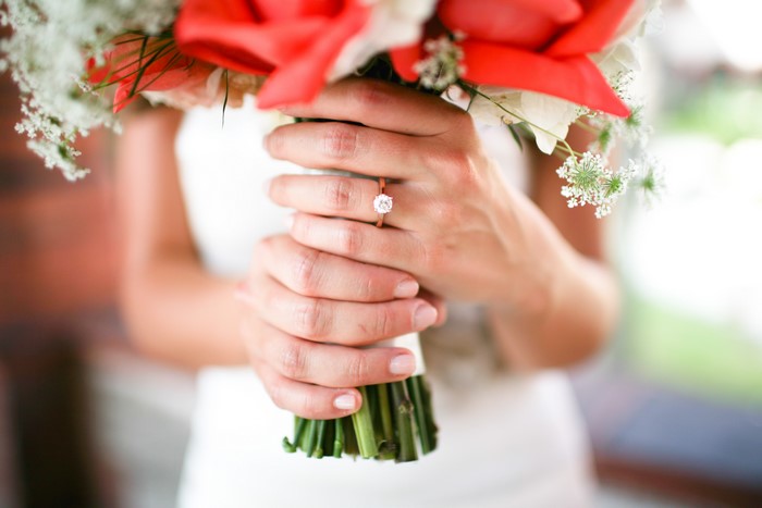 Bride holding bouquet with engagement ring