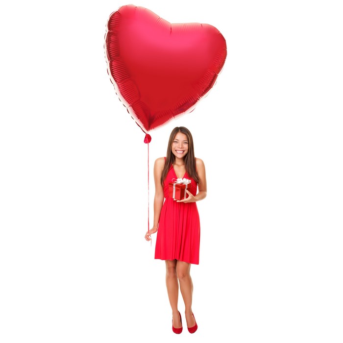 Woman holding a gift with a red heart balloon