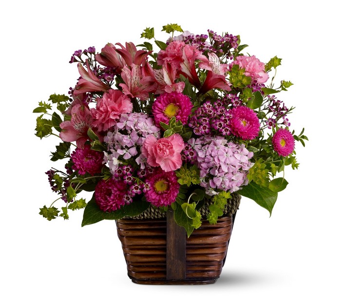 Pink and purple flower arrangement in a wicker basket