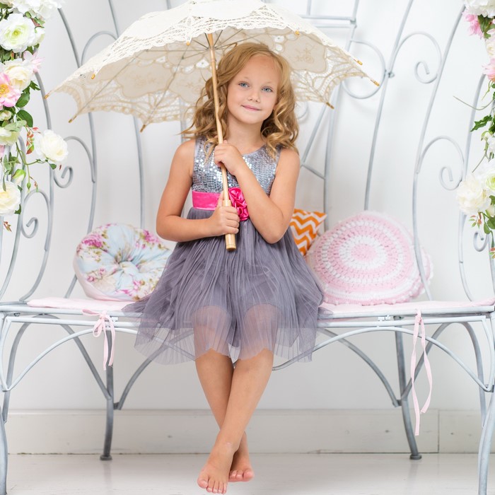 Girl in a dress holding an umbrella