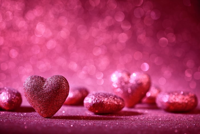 Pink glitter hearts on a bokeh background