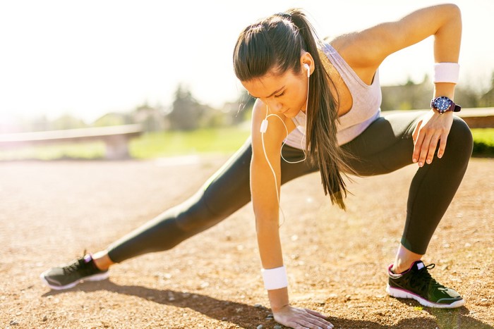 Woman Stretching Outdoors Before Workout