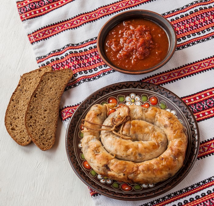 Sausage, Bread, and Tomato Sauce on a Table
