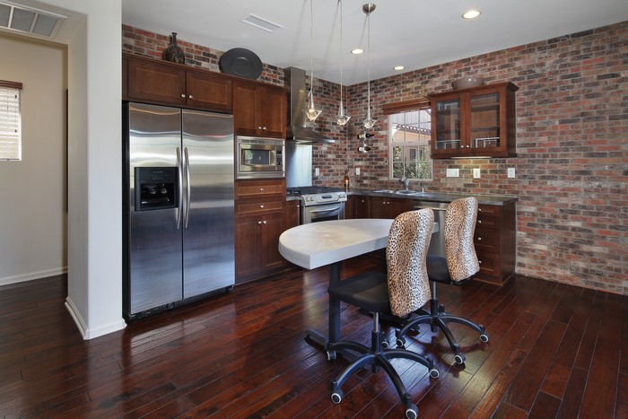 Kitchen with brick wall and island table