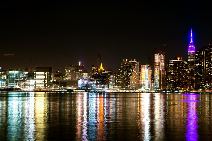 New York City skyline at night with reflections