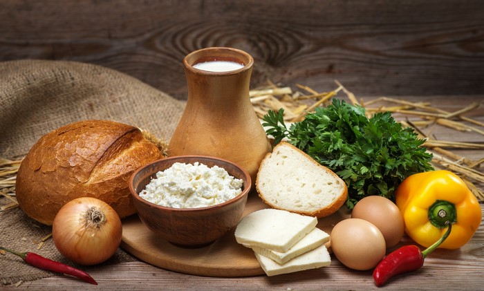 Still-life of dairy products, bread, eggs, and vegetables