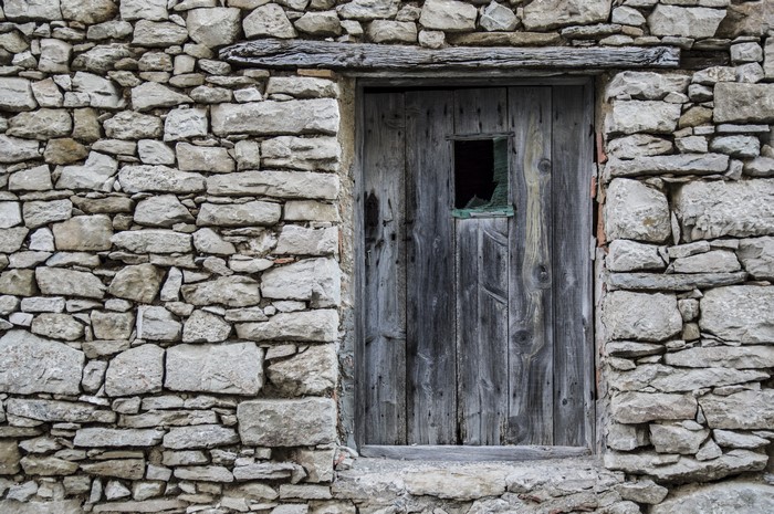 Wooden door in a stone wall