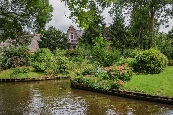 Giethoorn, Netherlands Canal with Houses and Gardens