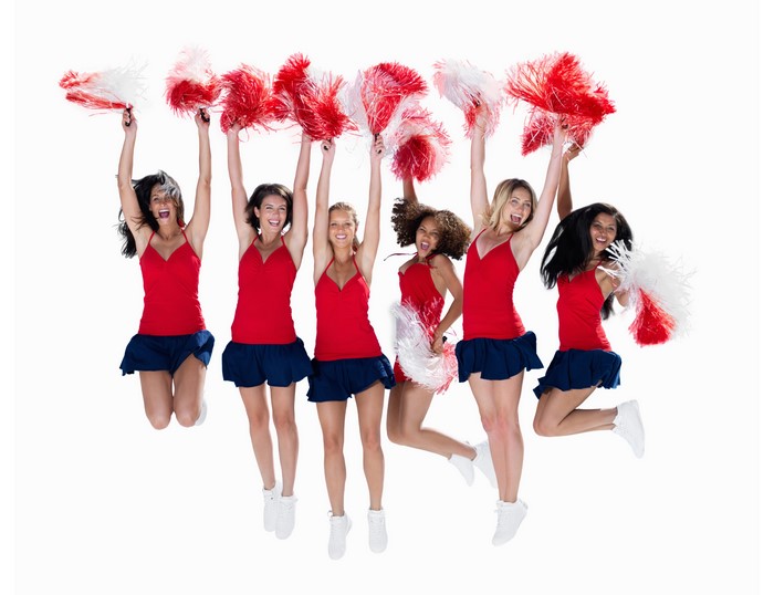 Cheerleaders in Uniform Jumping with Pom-poms