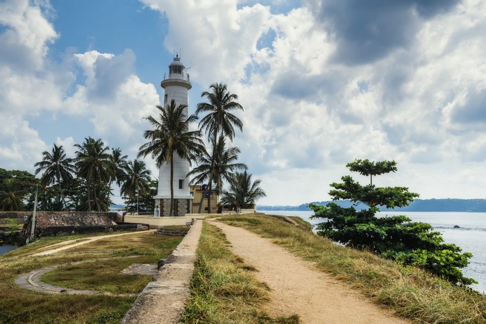 Lighthouse and palm trees in Galle, Sri Lanka