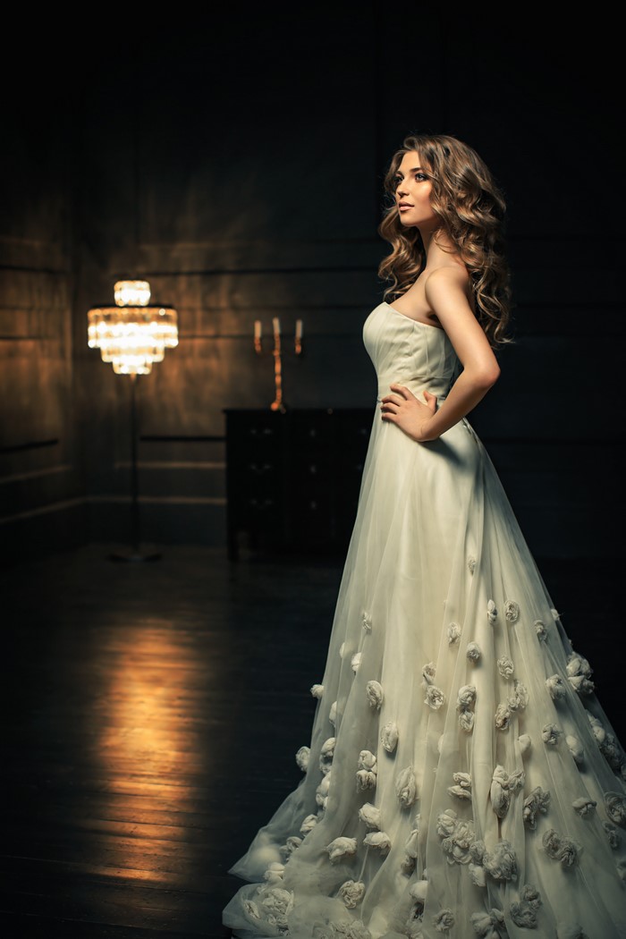 Woman in a white dress with floral embellishments