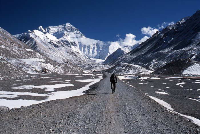 Man cycling towards Mount Everest
