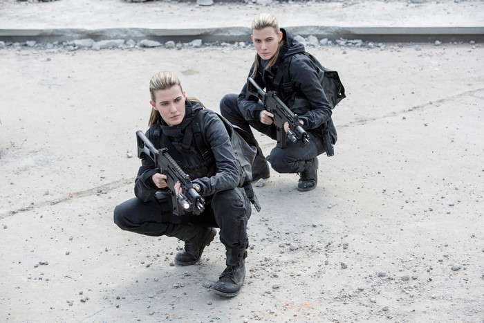 Misty and Kim Ormiston from The Hunger Games with assault rifles