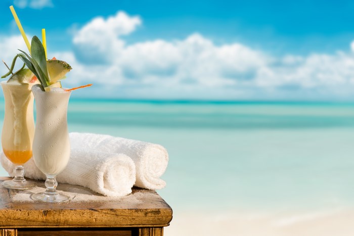 Cocktails and towels on a table by the sea
