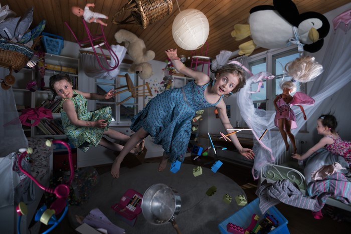 Children and toys in flight in a room