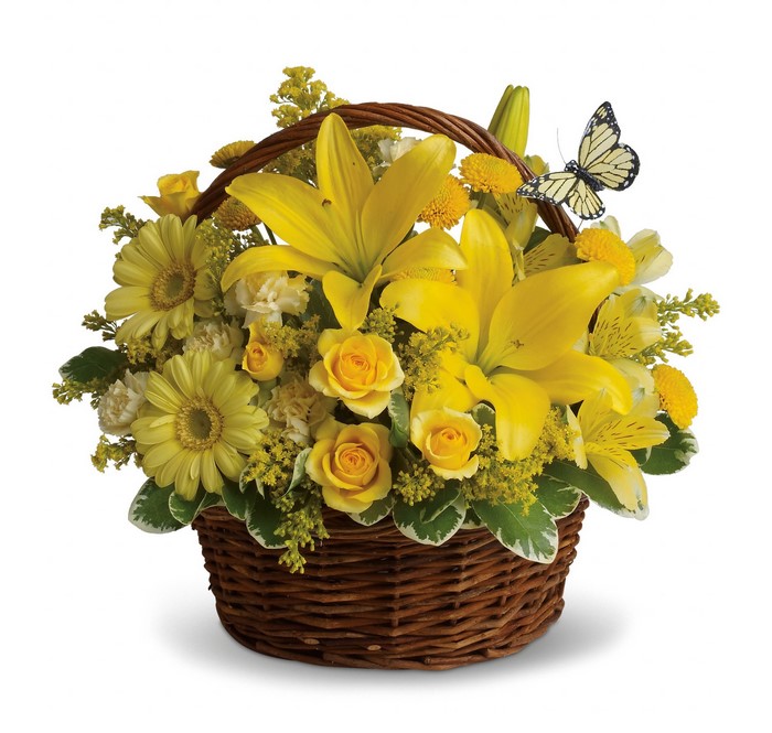 Yellow flower bouquet in a wicker basket with a butterfly