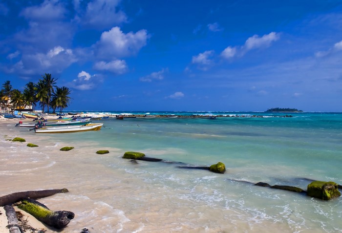 Boats on the coast of Colombia under a blue sky