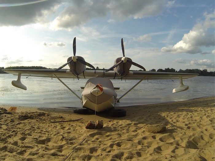Seaplane on a sandy beach by the water