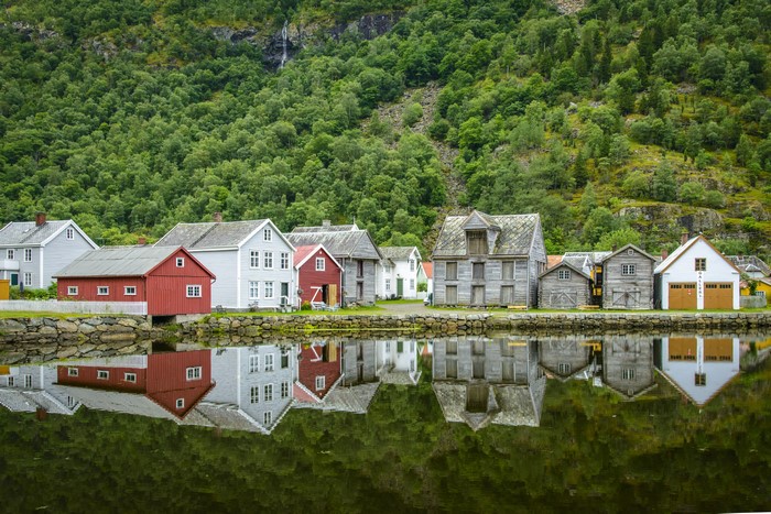 Houses in Laerdalsoyri, Norway with lake reflection