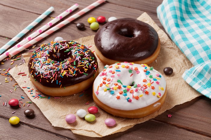 Three donuts with chocolate and icing sugar