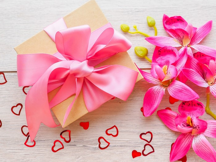 Gift box with pink bow and orchids