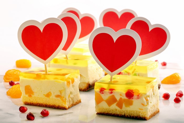 Little cakes with heart toppers and fruit