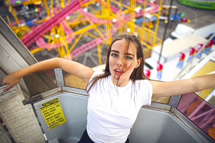 Young woman on a Ferris wheel at a carnival