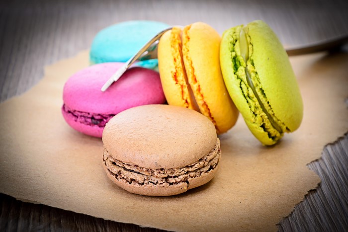 Colorful macarons on brown paper