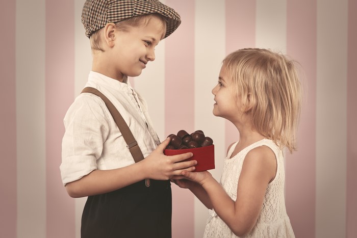 Boy giving chocolates to a girl
