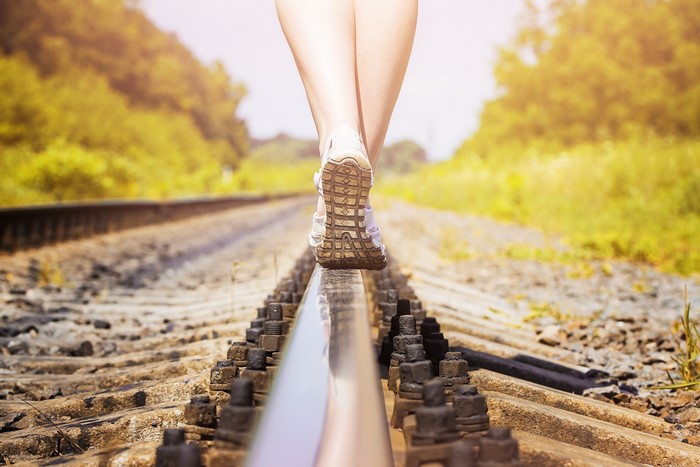 Person walking on railroad tracks
