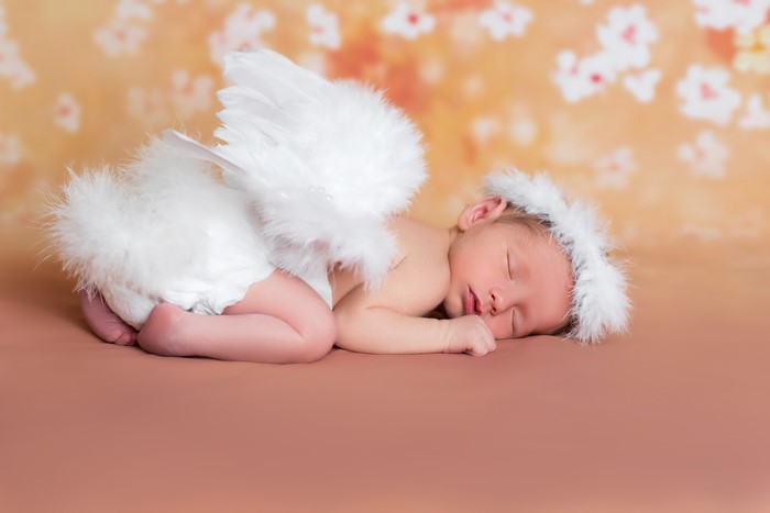 Baby angel sleeping with wings and halo