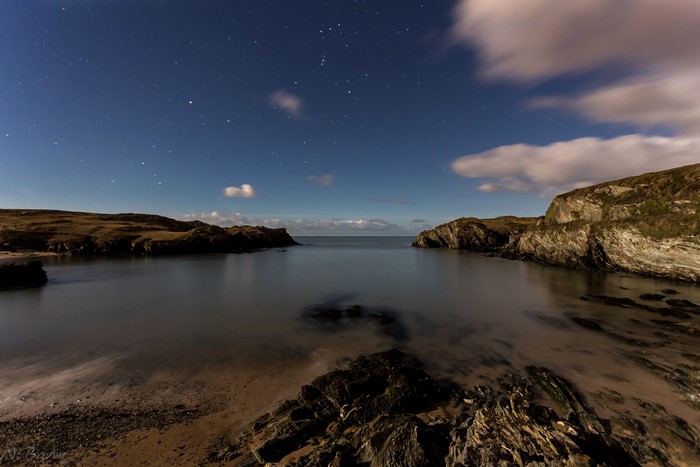 Porth Dafarch coast at night under a starry sky
