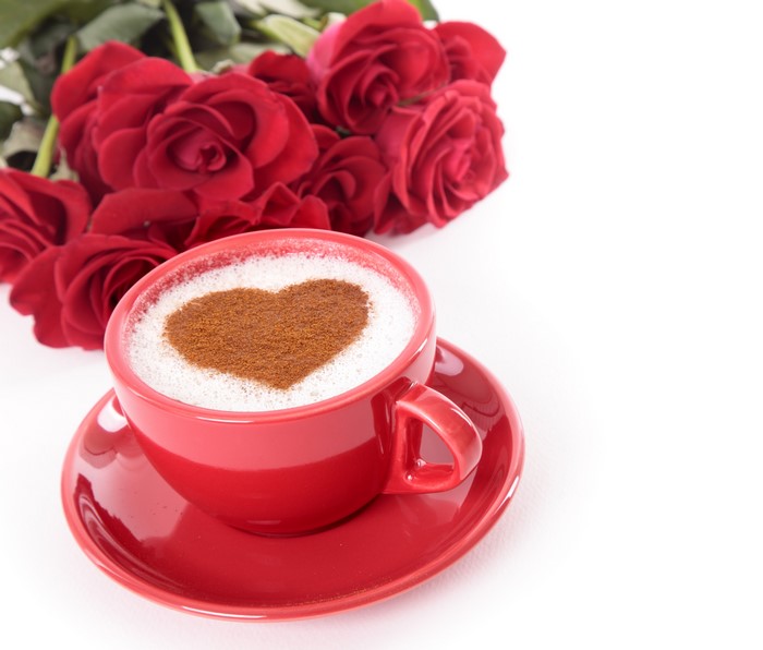 Red coffee cup with heart on saucer and red roses