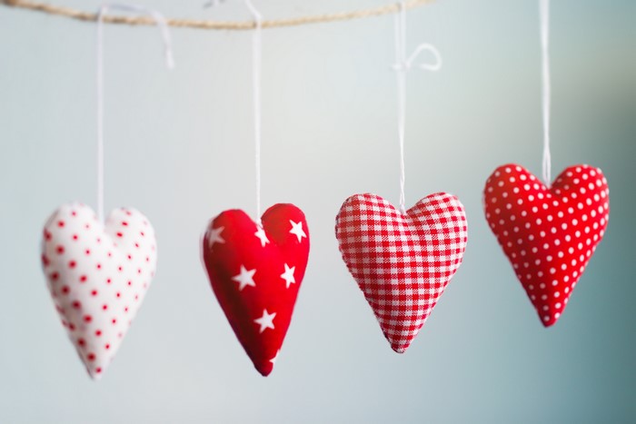 Four heart ornaments hanging on a string