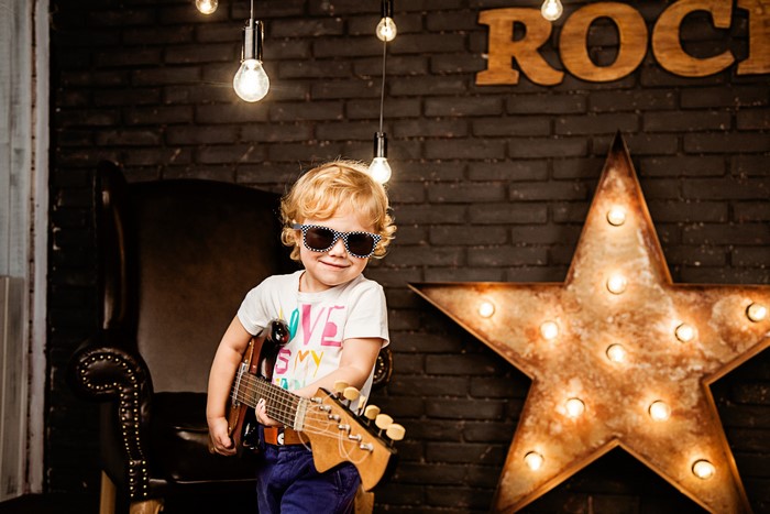 Boy with guitar and star decoration
