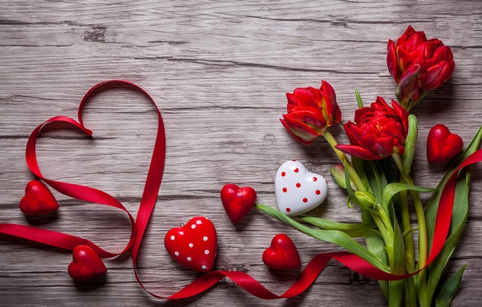 Red Tulips and Hearts with Ribbon on Wooden Background