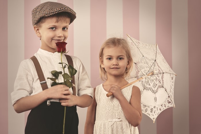 Boy with rose and girl with umbrella