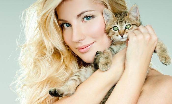 Blonde girl holding a kitten