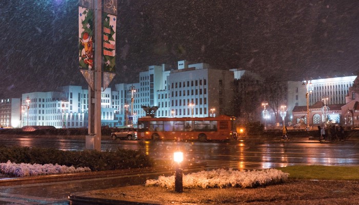 Orange bus on a snowy night in Minsk, Belarus