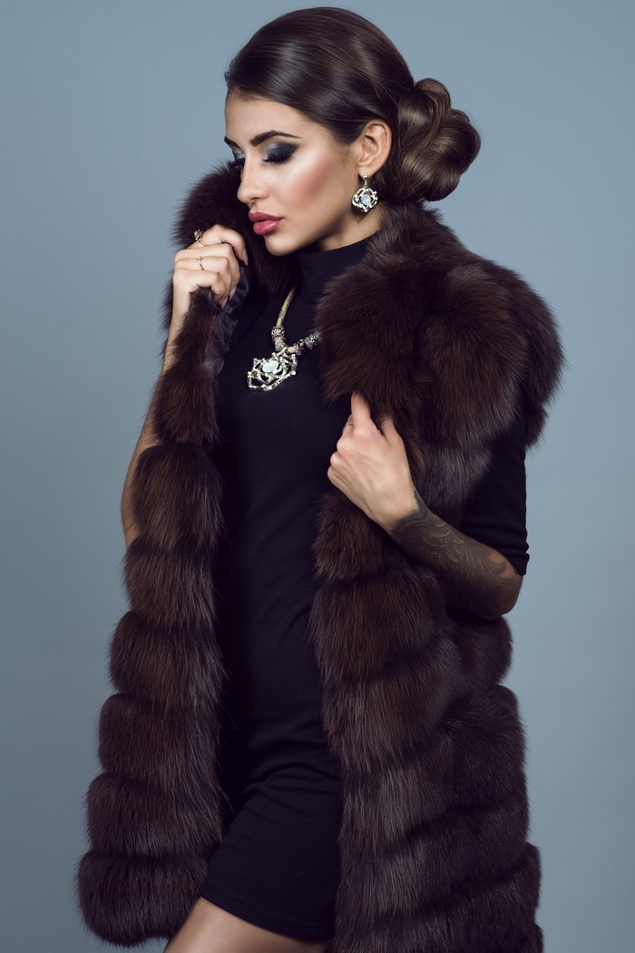 Woman in fur vest and black dress