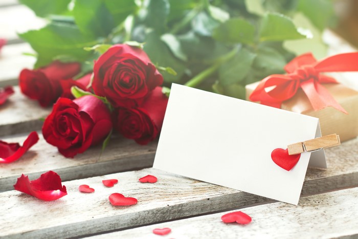 Red Roses and Valentine's Day Card on Wood