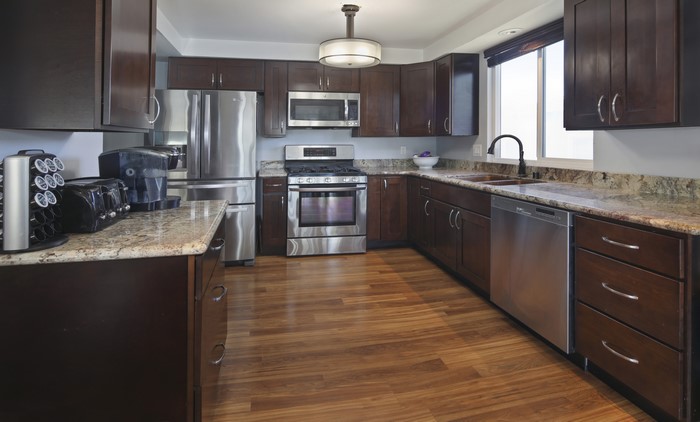Modern Kitchen with Dark Wood Cabinets and Granite Countertops