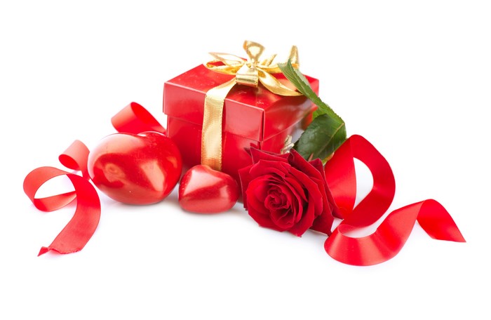 Red gift box with rose and ribbon on white background