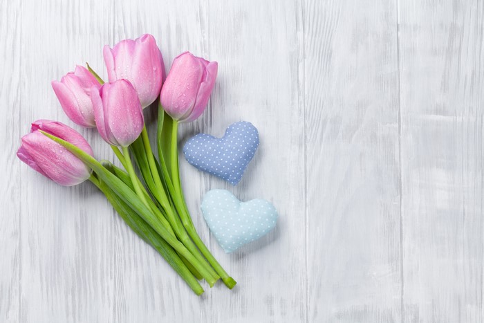 Pink Tulips and Blue Hearts on Wooden Background